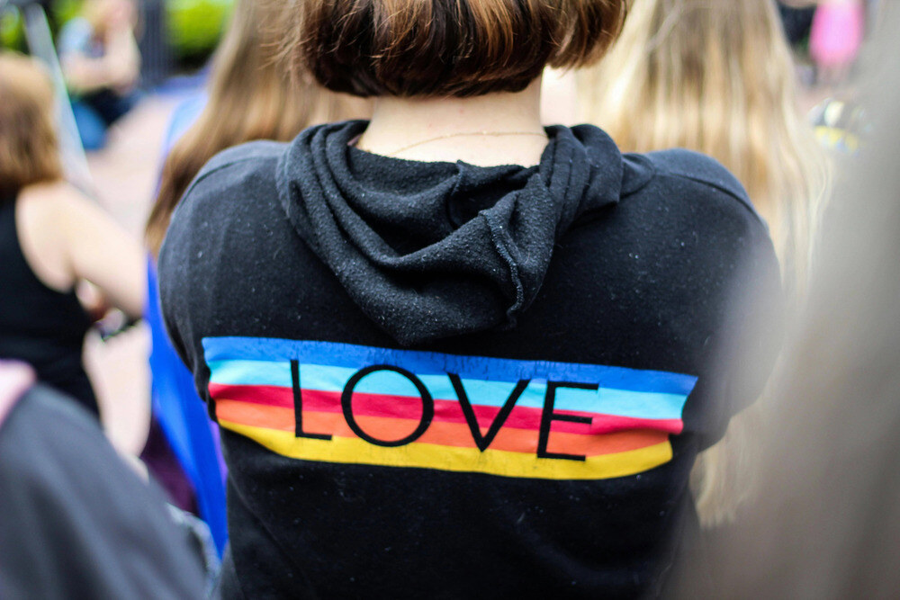 Person in Beaverton wearing hoodie with LOVE on back - LGBTQ+
