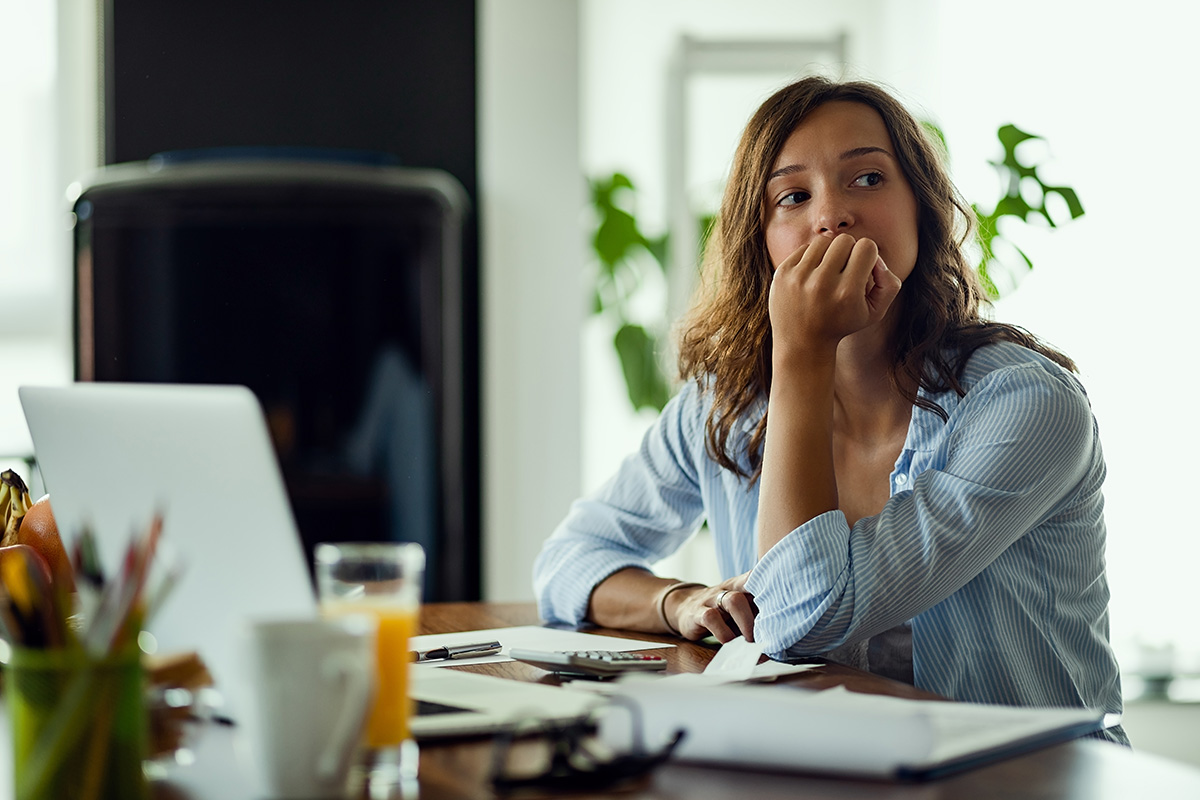woman in Beaverton stressed about money while sitting at desk