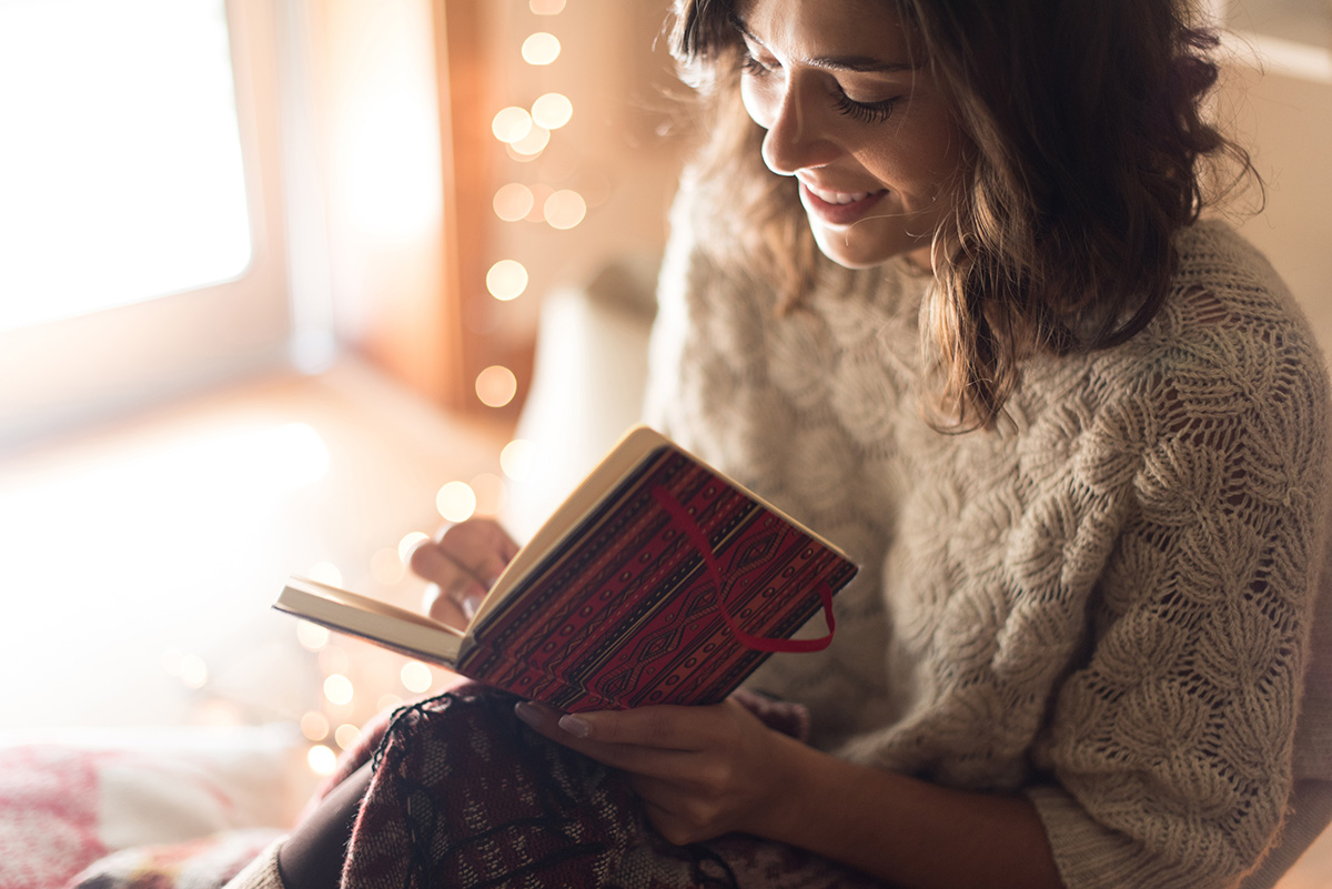 woman writing new years plans and past successes in journal